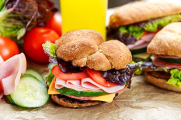Grilled Sandwich with lettuce, slices of fresh tomatoes, cucumber, red onion, salami, ham and cheese.