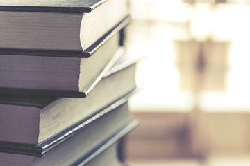 Stack of hardcover books on top of a desk