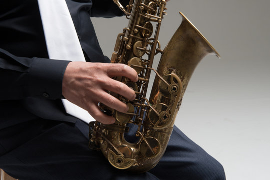 Hands of saxophone player, Close up studio portrait