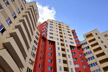 Fototapeta na wymiar Look up at the facade of multi-storey residential building.
