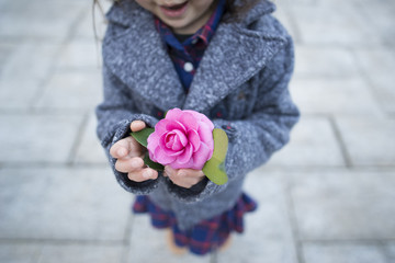 ピンクの花を持つ子供