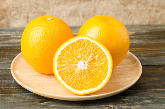 Fresh navel orange fruit on wooden background,healthy food