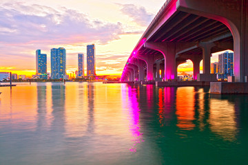 Miami Florida at sunset, colorful skyline of illuminated buildings and Macarthur causeway bridge - 98451675