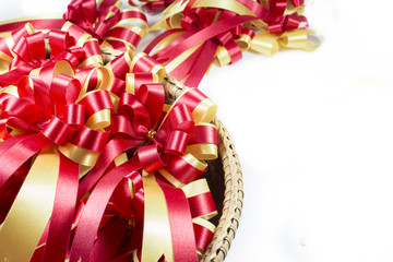 Gold and red ribbons with bow and space for text on white backgr
