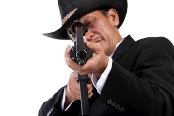 Gun pointed at camera, isolated on white