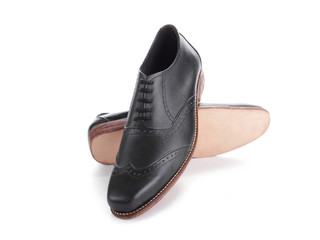 Black shiny shoes displayed on white