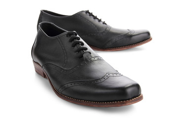 Black leather shoes closeup on white