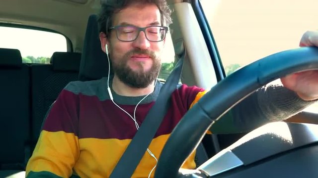 Happy man in love talking on the phone with girlfriend while driving car