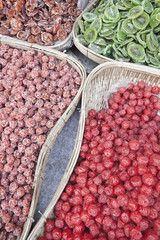 straw baskets filled with various kinds of dried fruit