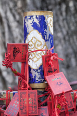 Wish cards bound around a weathered pole in a Taoist temple, Beijing, China