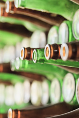 Play of light, reflection and transparancy on a wall of empty beer bottles