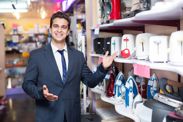 Male seller at household appliances section