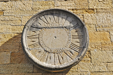 old sundial on a brick wall