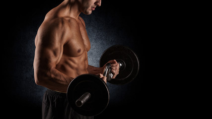 Fototapeta na wymiar muscular young man lifting weights