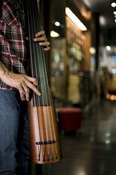 Close up of a man playing electric double bass