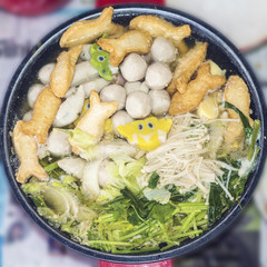 Sukiyaki are being cooked in pot.