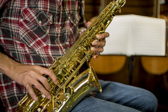 Close up of a man playing Alto Saxophone