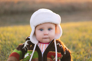 Adorable Baby Girl in Winter Hat and Sweater Outside