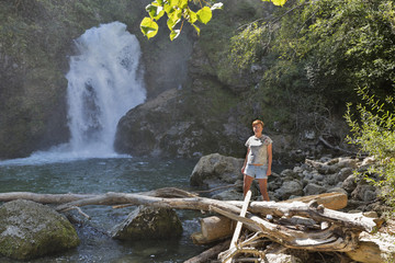 Woman in front of waterfall Sum, Vintgar gorge, Slovenia