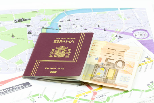 Spanish passport with european union currency banknotes on prague map
