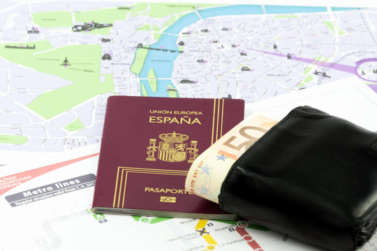 Spanish passport with european union currency in a wallet and map as a background
