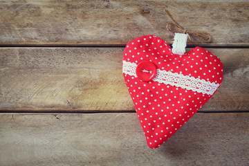 top view image of colorful fabric heart on wooden table. valentine's day celebration concept
