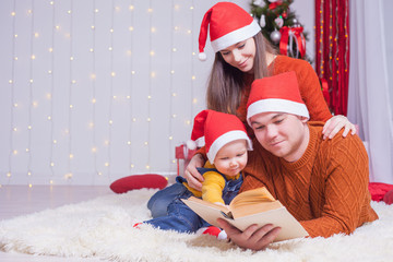 Happy family reading a book with christmas fairy tale