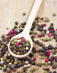 Color pepper on a wooden background.