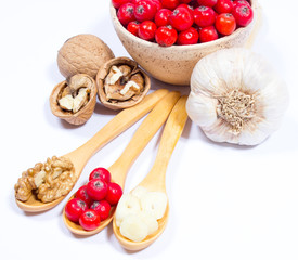 Fresh fruit of hawthorn, garlic and walnuts. The concept of alternative medicine.