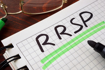 Notebook with RRSP  sign on a table.  
