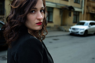 Fototapeta na wymiar beautiful woman with red lips walks in the city