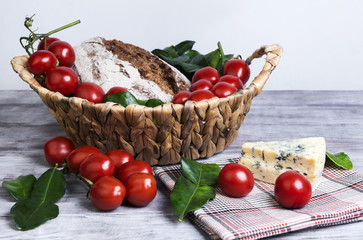 lunch basket of cherry tomatoes on a branch, bread