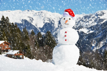 Snowman against Alpine panorama