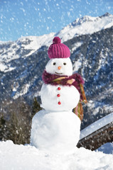 Snowman against Alpine panorama