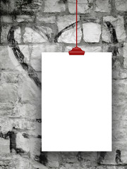 Close-up of one clipboard with red clip on graffiti stone wall background