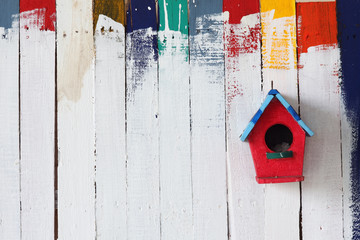 colorful bird house on grunge wall