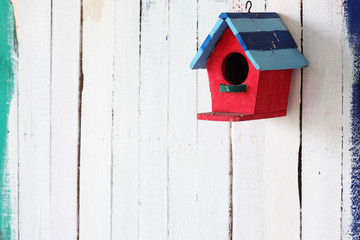 colorful bird house on grunge wall