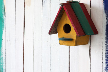 colorful bird house on grunge wall