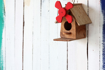 colorful bird house on grunge wall