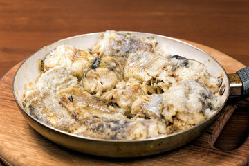 Fried pollock in the pan