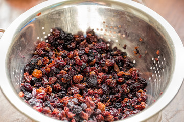 Red and black raisins in a colander
