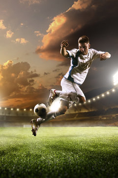 Soccer player in action on sunset stadium background