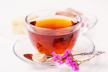 Ceylon tea in a transparent cup with a slice of sugar