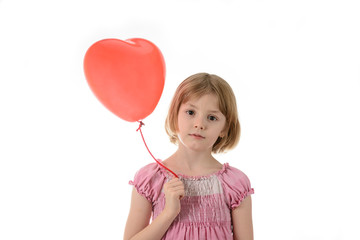 Little girl in pink dress holding a balloon