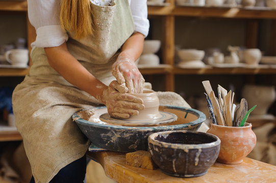hands of a potter, creating an earthen jar on the circle