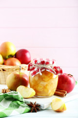 Fototapeta na wymiar Apple jam in jar on a white wooden table