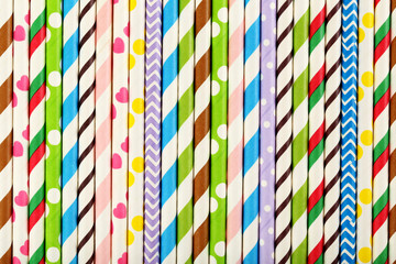 Striped drink straws background, close up