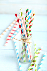 Striped drink straws on a blue wooden background
