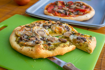 Freshly baked artisan pizza with fresh produce and cheese.