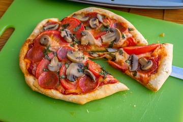 Freshly baked artisan pizza with fresh produce and cheese.